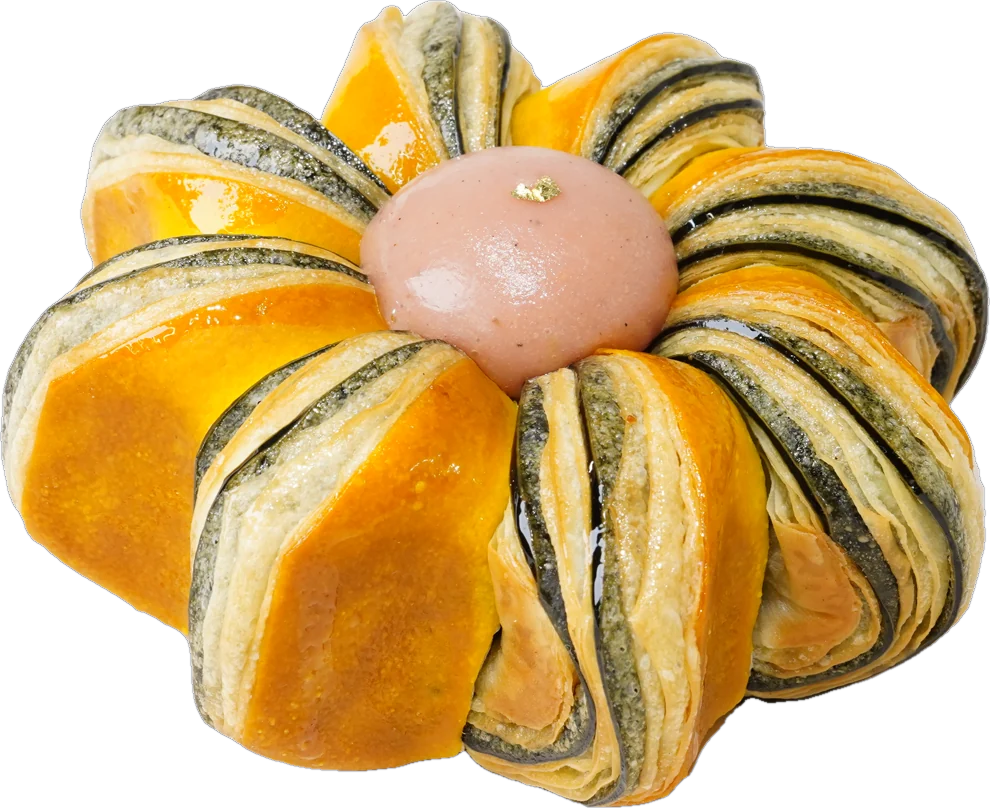 Pink Guava Twist · Bánh ngàn lớp hình bông hoa sọc cam và xanh sẫm, giữa có một viên kem màu hồng · Flower-shaped laminated pastry with orange and dark green stripes and a pink dome in the centre